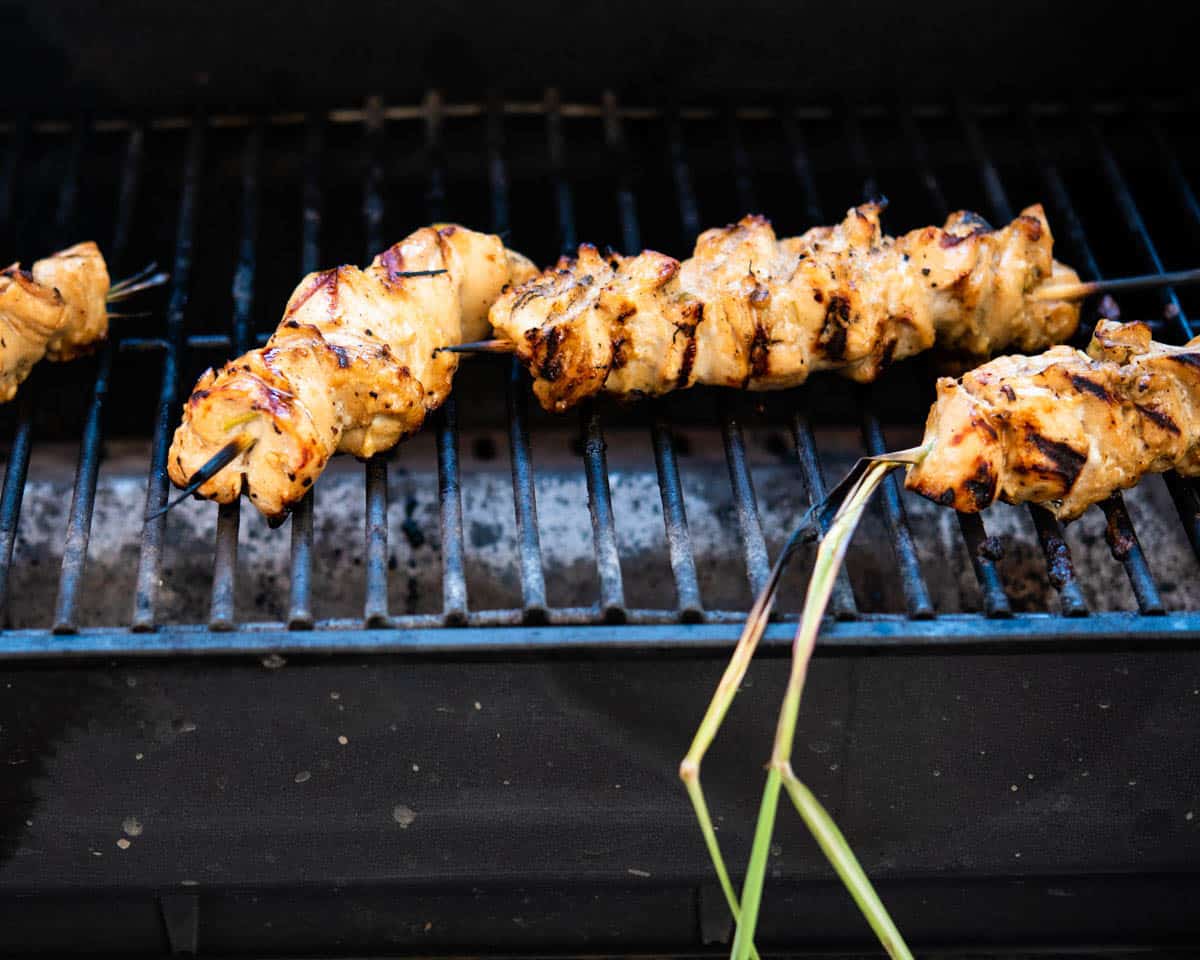 chicken skewers cooking on the grill