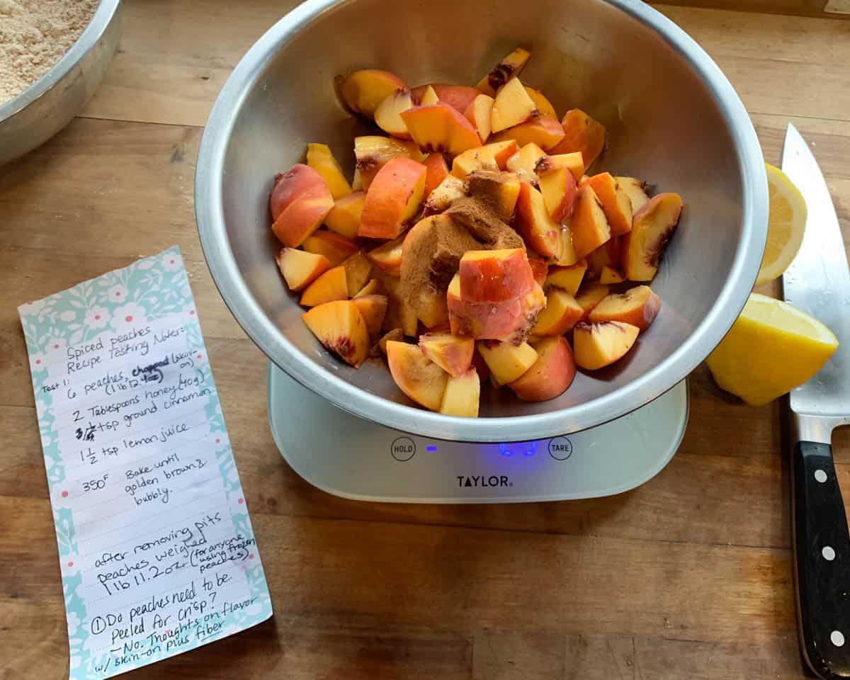 chopped peaches with cinnamon and honey in mixing bowl