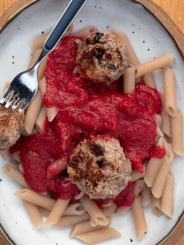 baked pork beef meatballs served with nomato sauce and cassava pasta