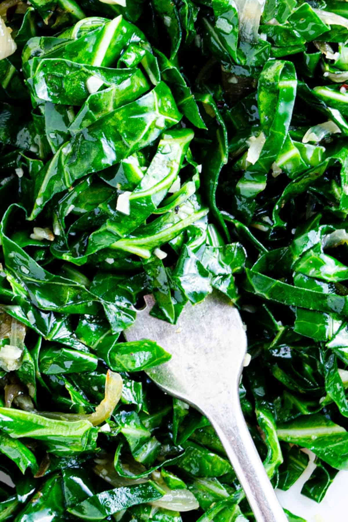 bright green cooked kale on fork