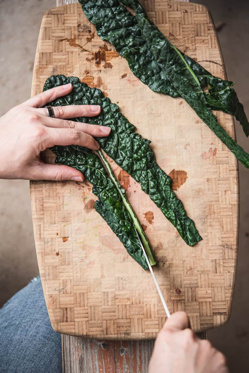 cutting kale on cutting board to remove stem