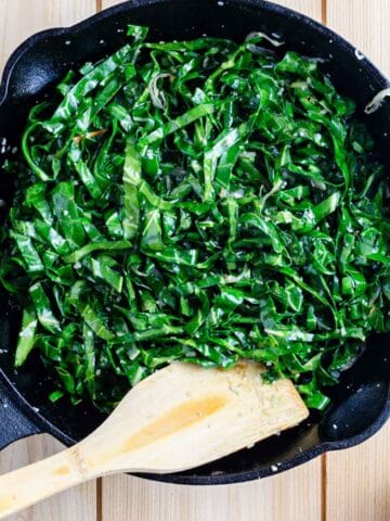 kale sautéed with garlic and shallot in pan