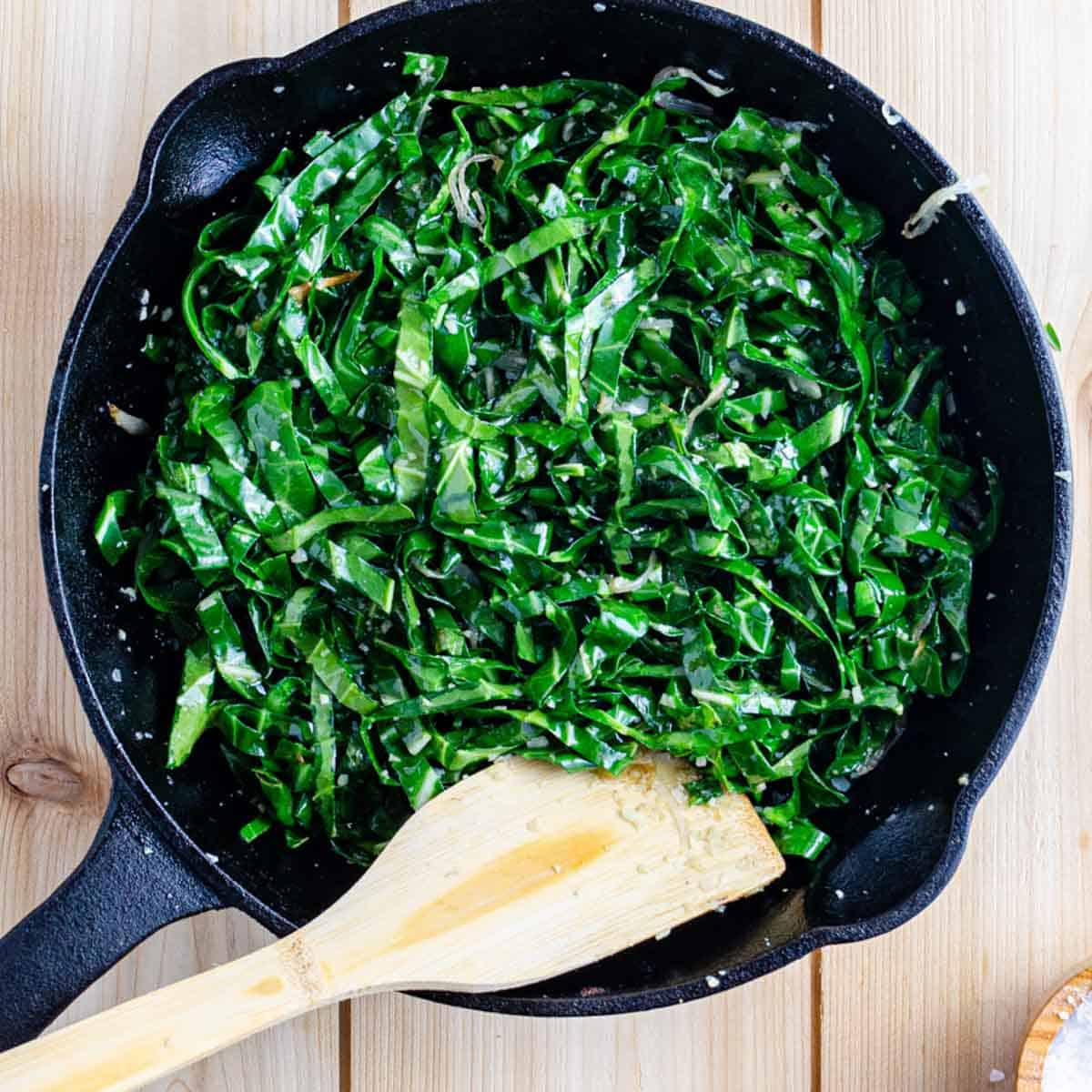 kale sautéed with garlic and shallot in pan