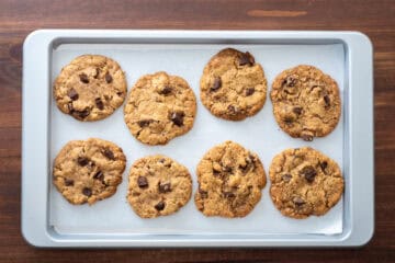 baked chocolate chip cookies on a baking sheet