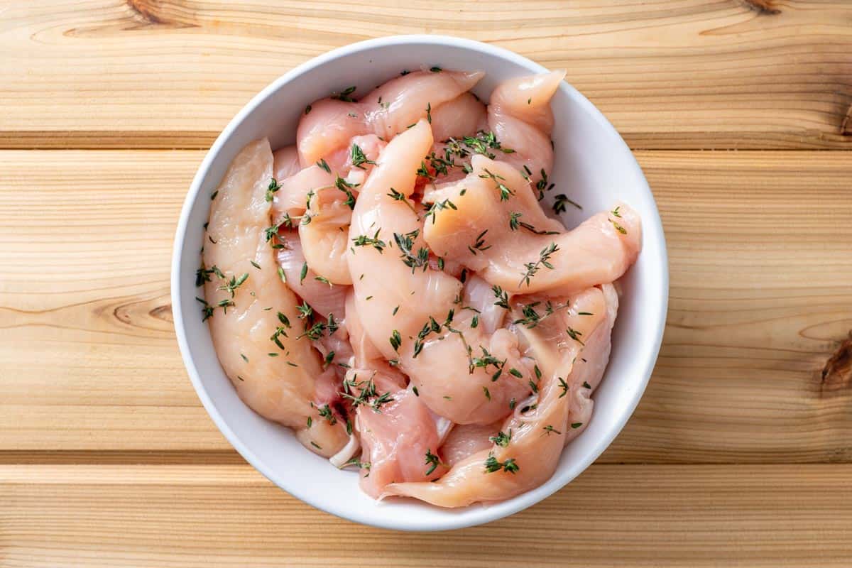 chicken tenders with thyme in bowl