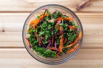 finely chopped kale, carrot, and cabbage slaw in bowl