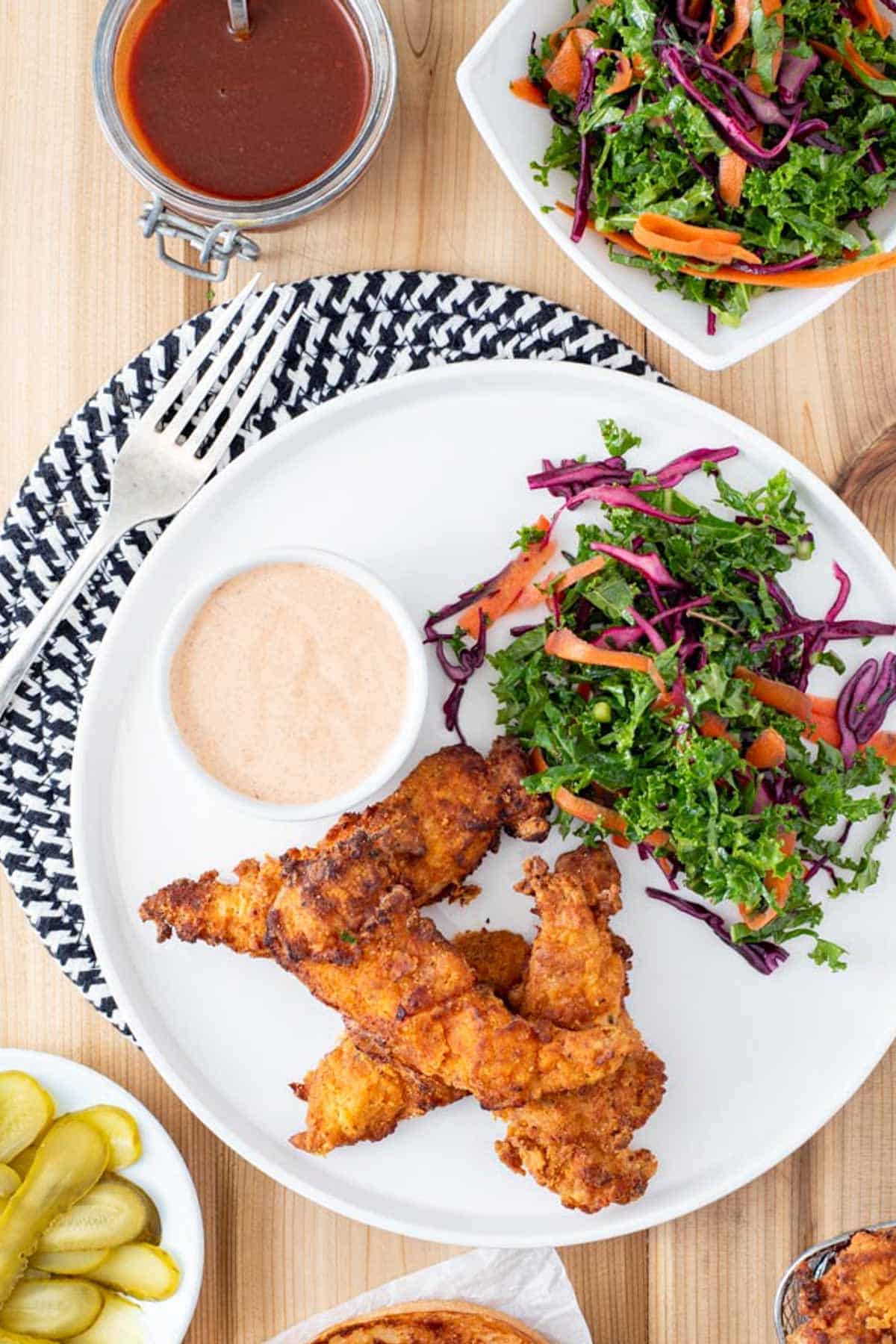 AIP chicken tenders on plate with kale slaw and AIP ranch dip
