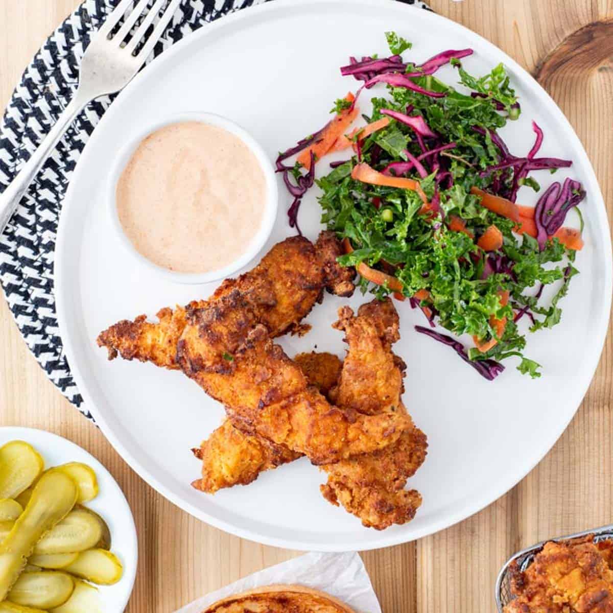 AIP chicken tenders on plate with sauce and slaw