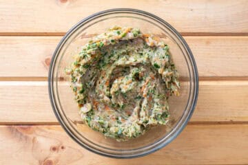 ground chicken mixed with shredded vegetables in bowl
