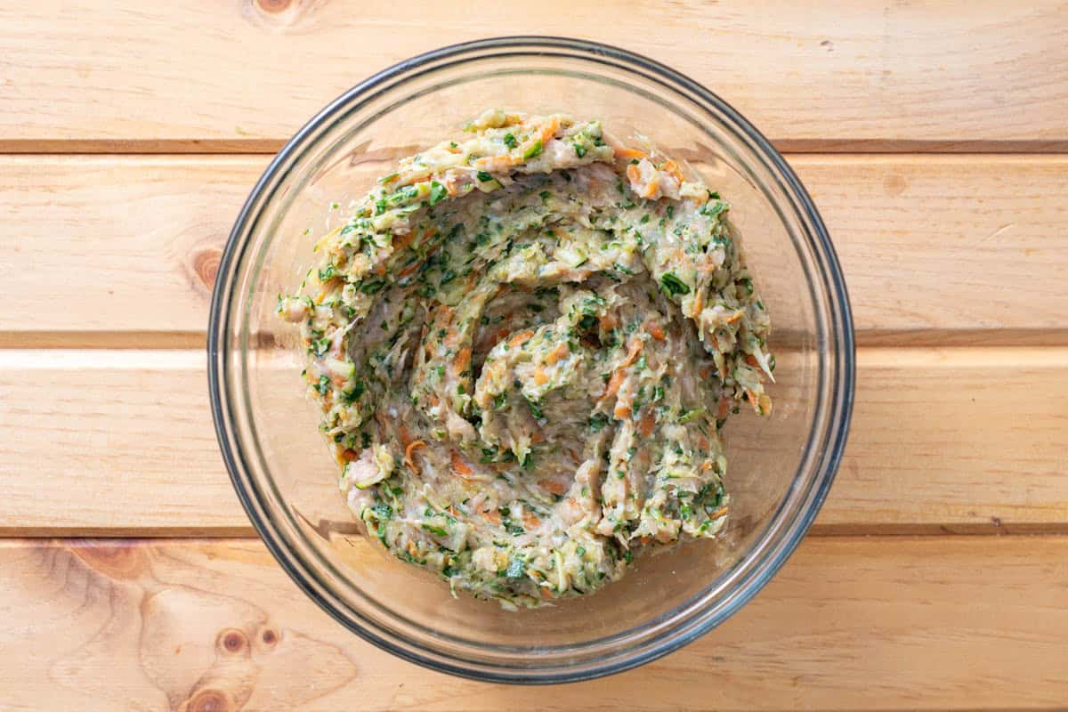 ground chicken mixed with shredded vegetables in bowl