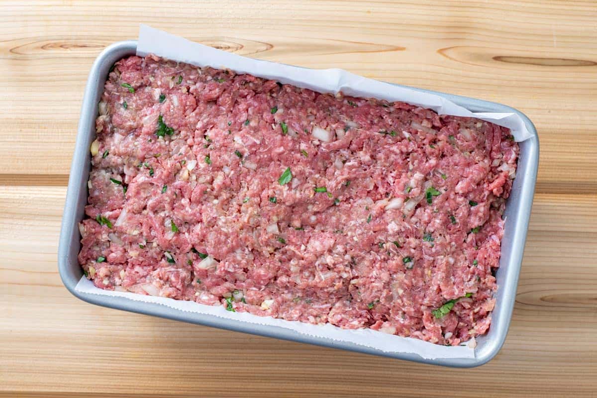 meatloaf mixture in parchment lined baking dish