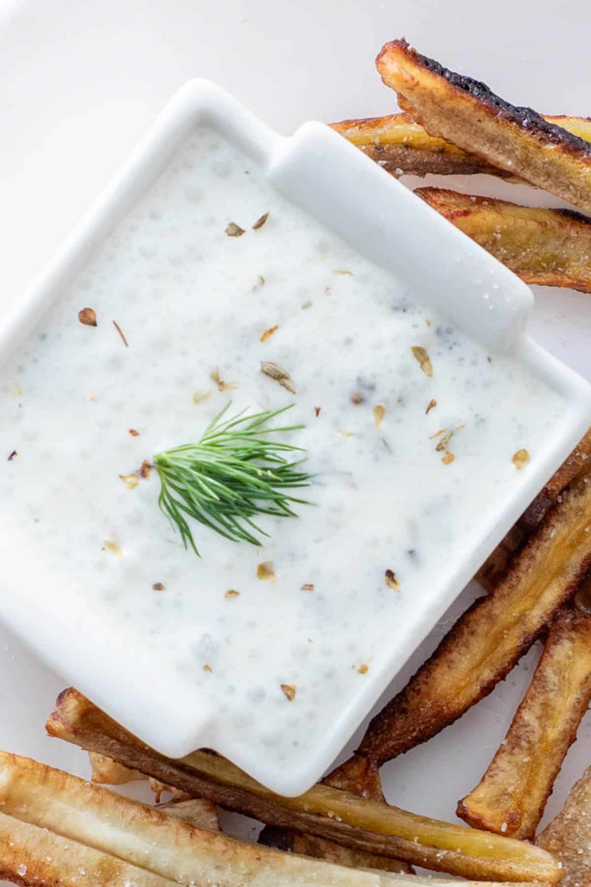 dairy free ranch dip in ramekin on plate with fries