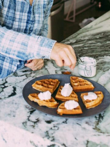 AIP waffles with coconut whip on a plate