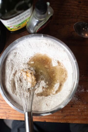 oil and maple syrup in bowl with dry ingredients