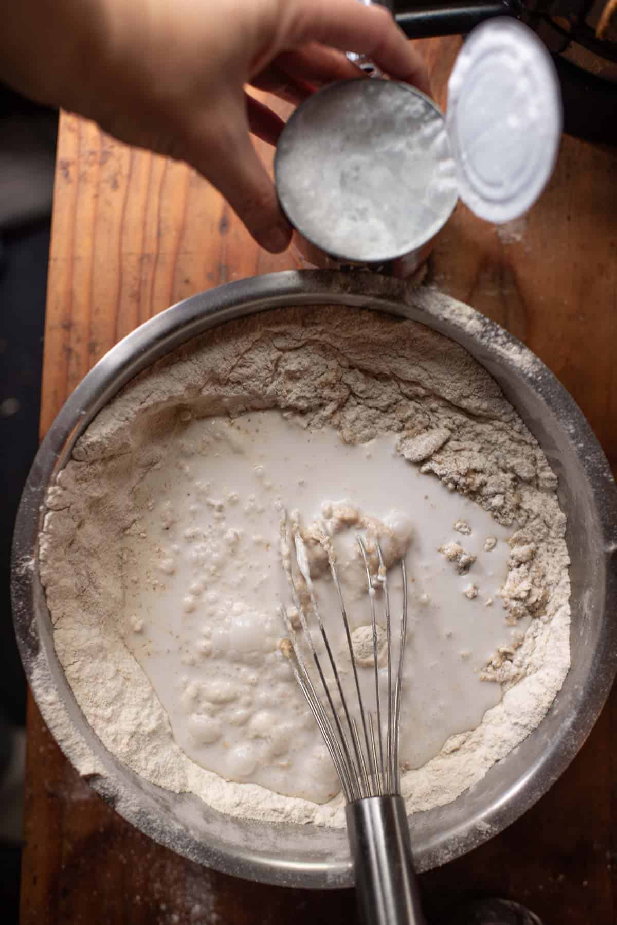 coconut milk and water added to mixture in bowl