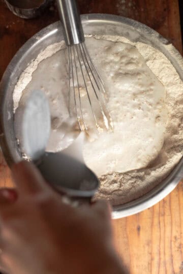 coconut milk plus water added to mixture in bowl