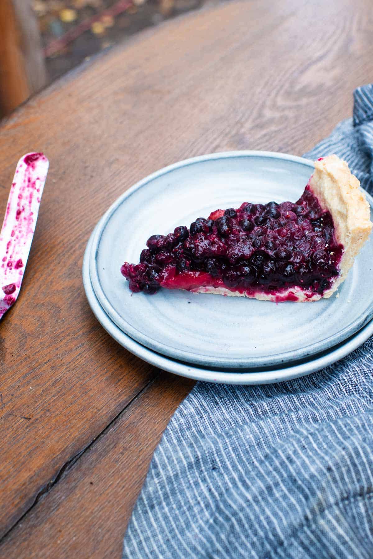 blueberry and strawberry pie slice on plate